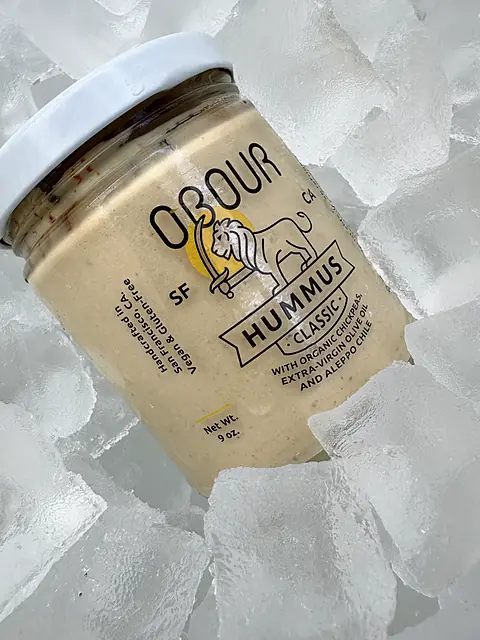 A jar of Obour Classic hummus on ice