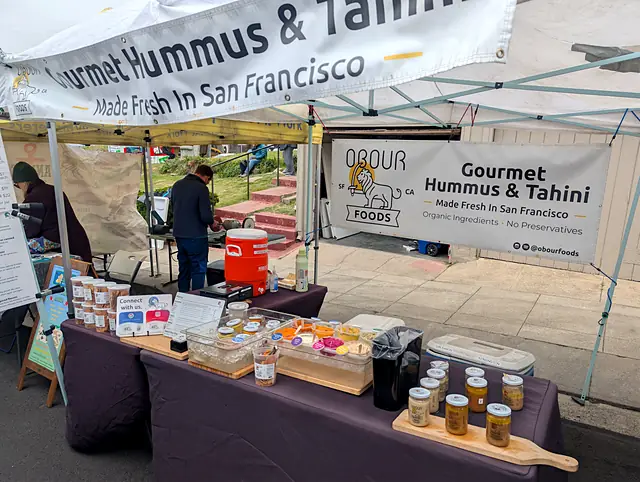 The Obour market table with samples, jars and a board of tahini