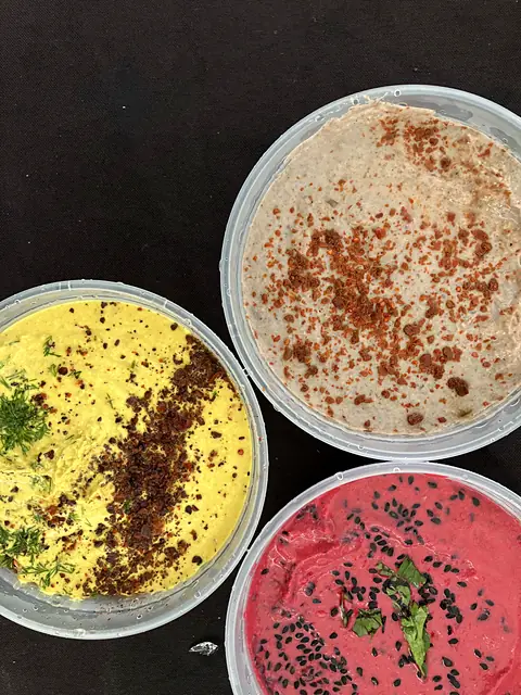 Tubs of Hot Curry, Classic and Red Beet hummus from above