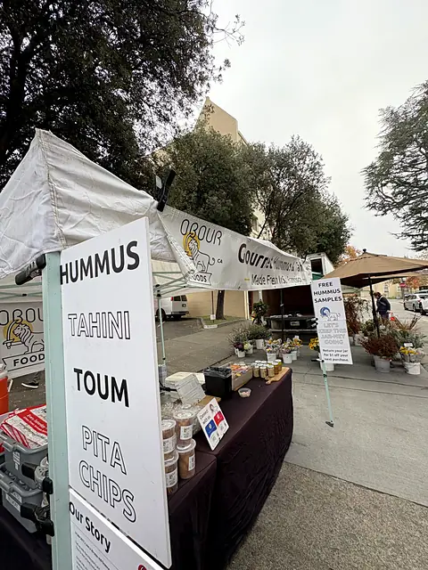 The Obour side sign listing hummus, tahini, toum and pita chips