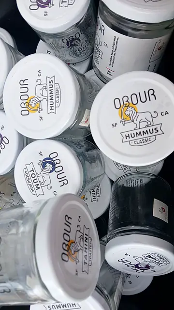 Empty Obour glass jars packed in a crate, seen from above