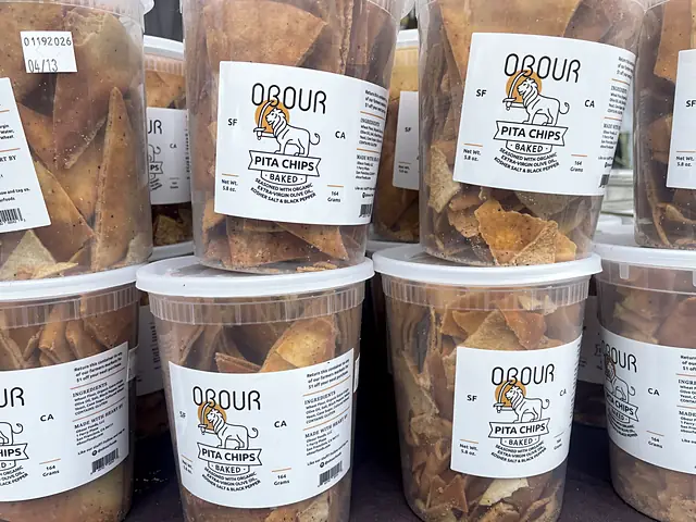 Stacks of Obour pita chip tubs on the market table