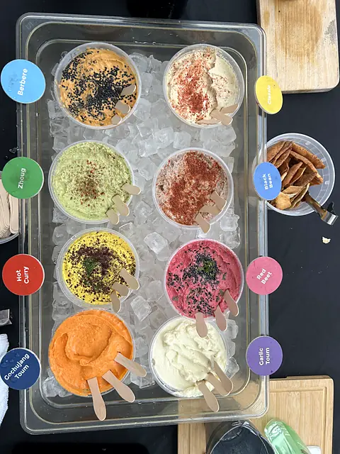 A labeled tray of Obour samples on ice next to a bowl of pita chips