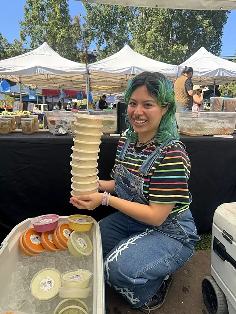 A team member stacking sample cups at the Obour stand