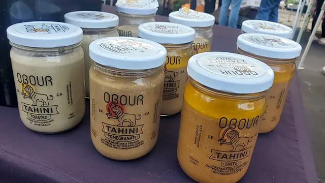 Jars of Obour Toasted, Pomegranate and Date tahini on the market table