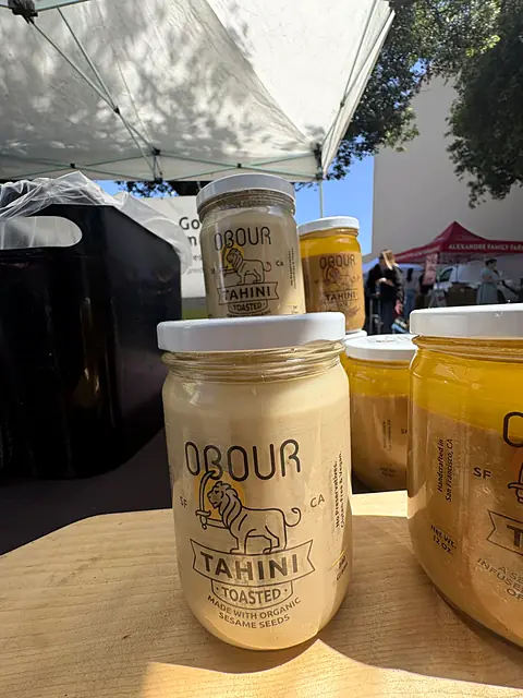 A jar of Obour Toasted tahini on the market table