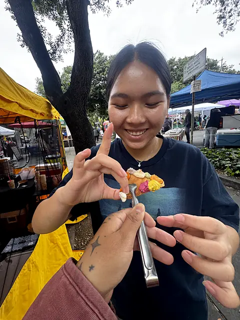 A shopper smiling as she tries an Obour sample on a chip