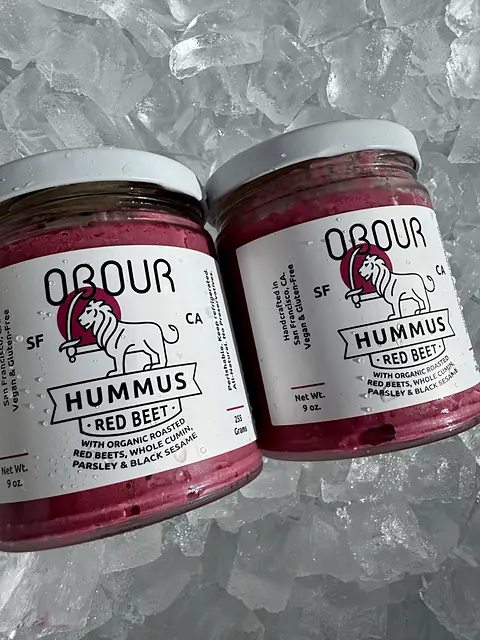 Two jars of Obour Red Beet hummus on ice