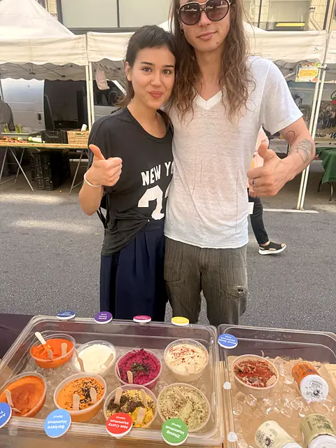 Two shoppers giving thumbs up behind the Obour sample tray