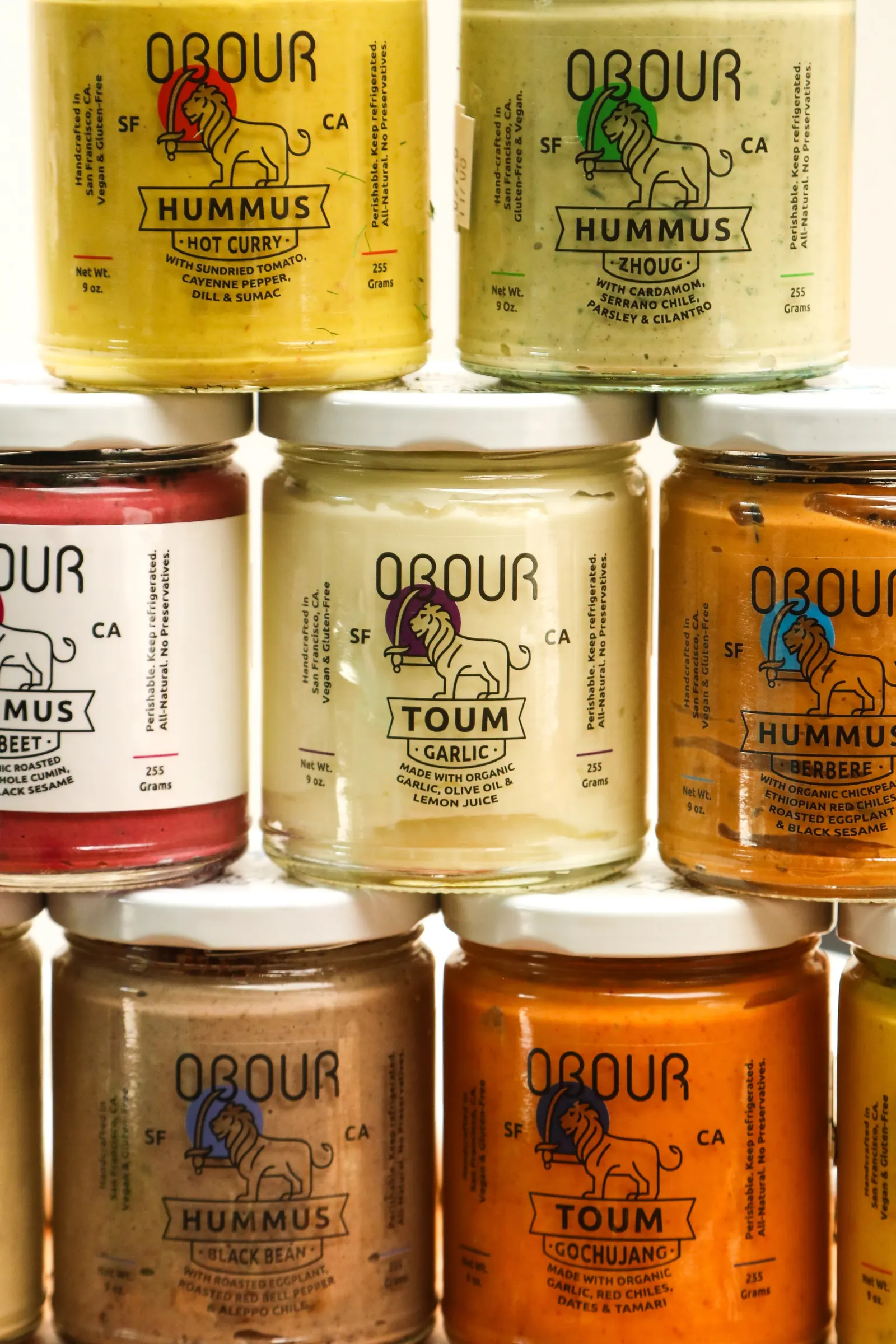 A wall of stacked Obour glass jars